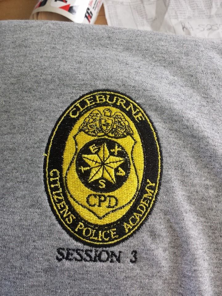 Embroidered Cleburne Citizens Police Academy patch on grey fabric.